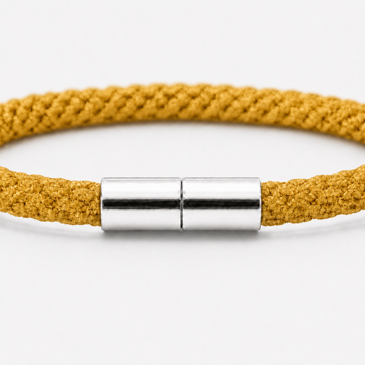 Detailansicht eines Kumihimo Armbands in Goldgelb mit glänzendem Edelstahlverschluss.